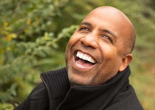 A man smiling outdoors